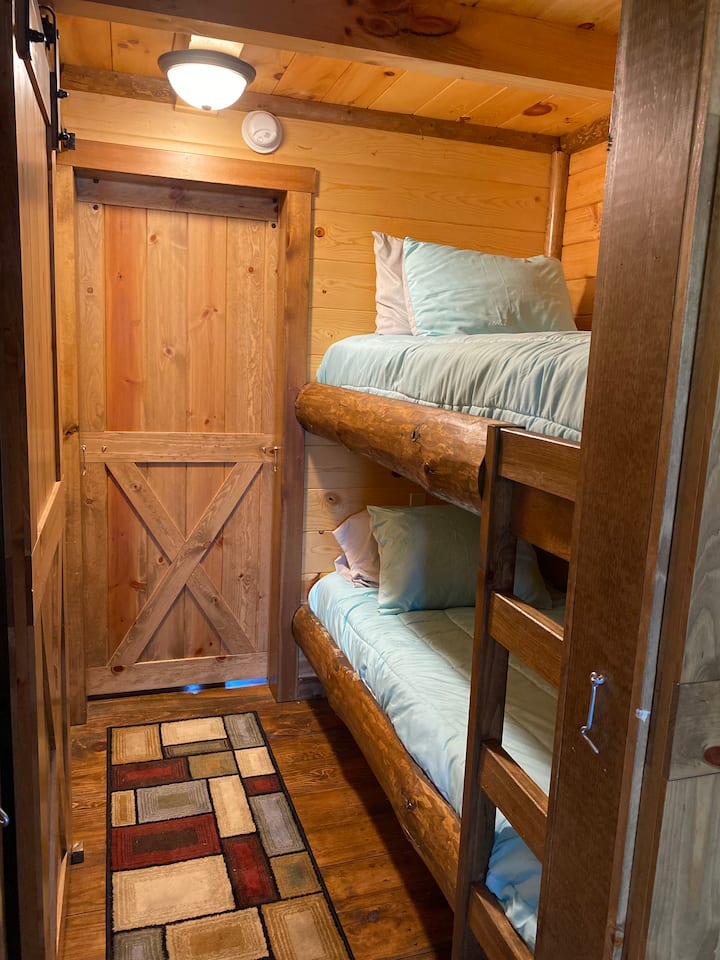 Natural log bunk beds with twin mattresses.