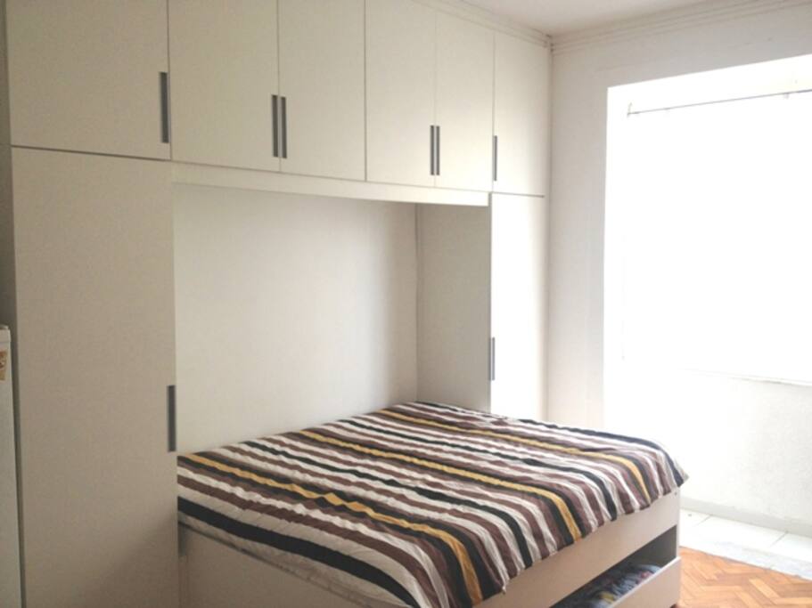 Armários, cama casal e sacada
