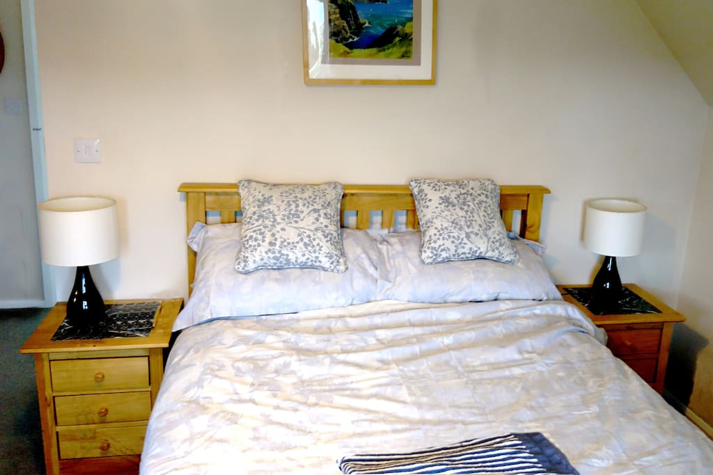 Double bed with view to the hills and sea