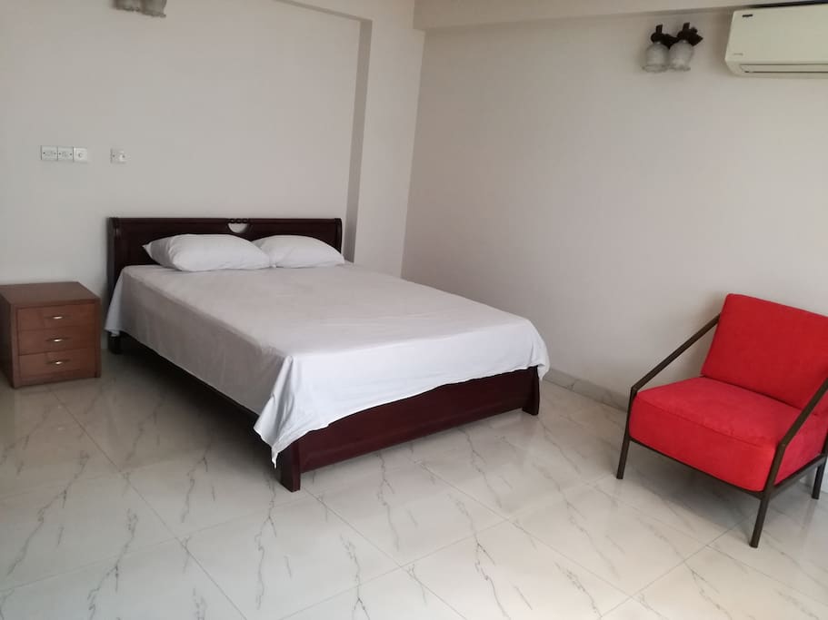 This the second room of our apartment. There is also one attached bathroom, one king size bed with one side drawer, one single sofa chair. Air Condition is also available.
