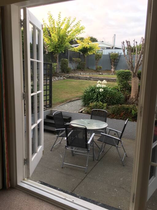 Living area that can open up through French Door to private Outdoor seating area in the Garden