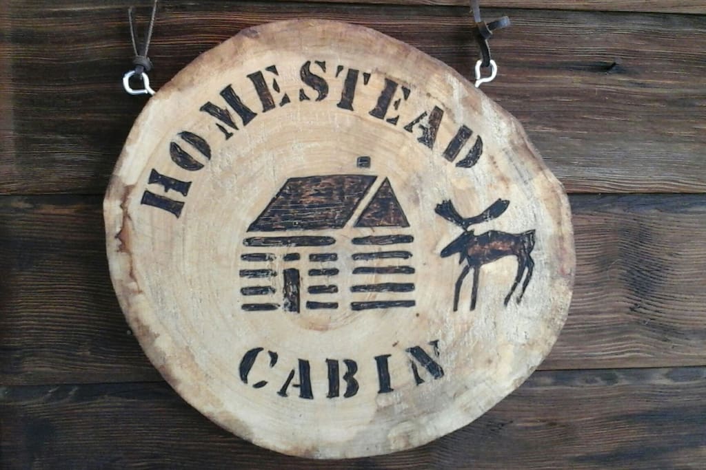 Cabin sign to the right of the cabin door entrance.