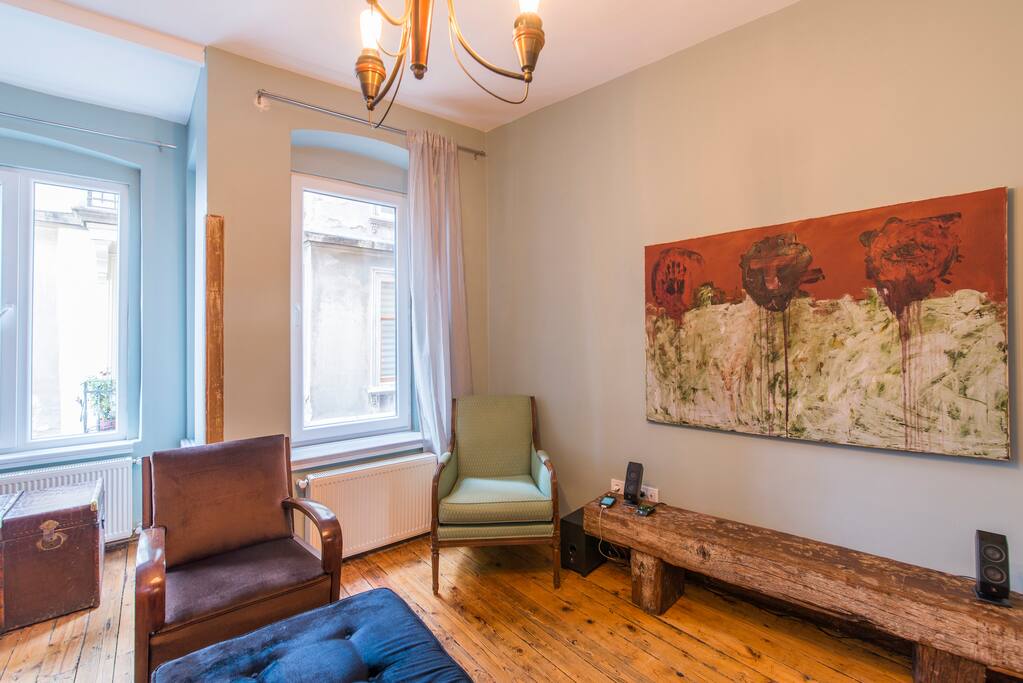 Living-room with collectable vintage furniture and art-work on the wall..
