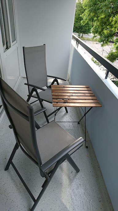 Balcony with 2 chairs and a garden table