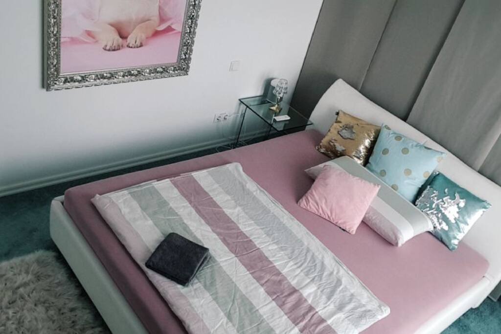 Across from the bed: a 55inch Flat TV