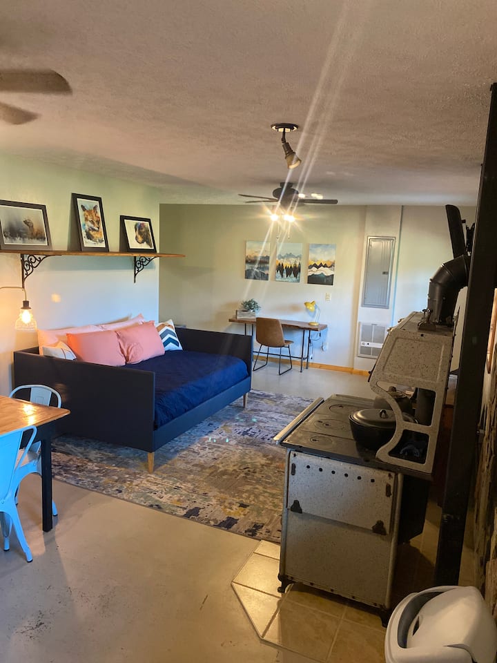 Downstairs living/dining area with kitchenette and full day bed.