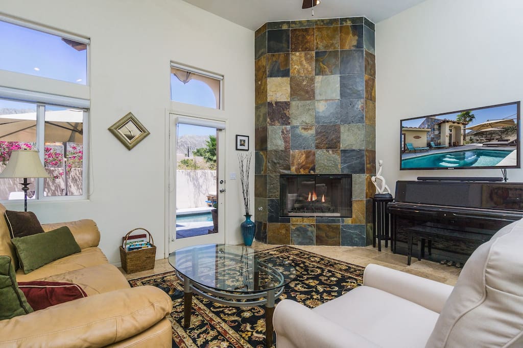 Seating faces the 55” flat screen TV and fireplace in the living room