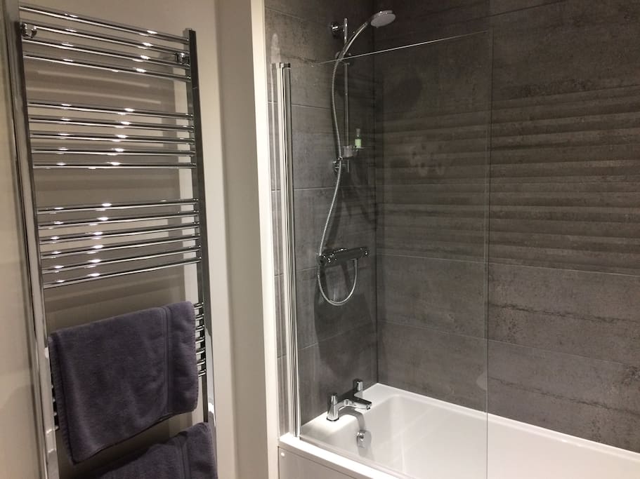 Bathroom with shower over bath and heated towel rail