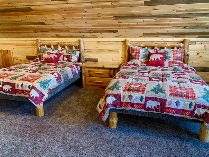Upstairs in the loft there are three queen-sized log beds. 
