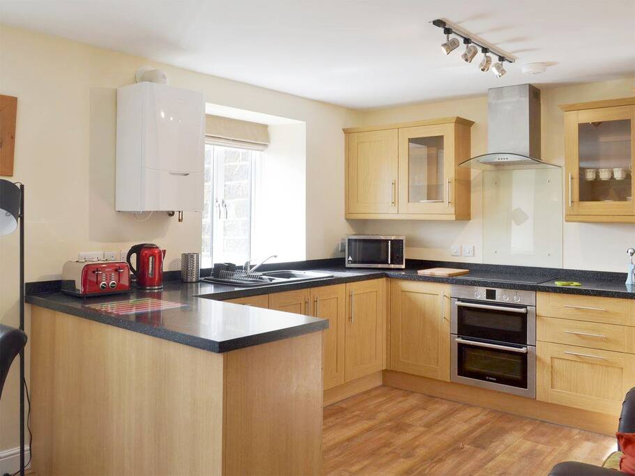 Full size kitchen, part of open plan dining and living area.