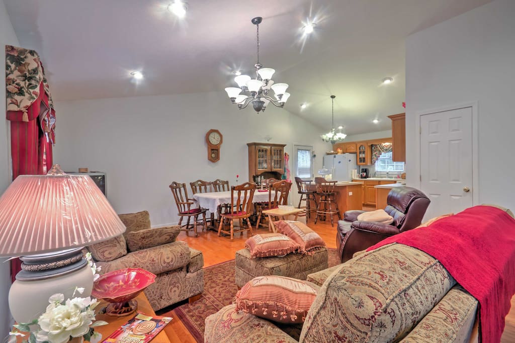 Enter to find a spacious, open floor plan adorned with beautiful hardwood floors that combines the living room, dining area and kitchen.