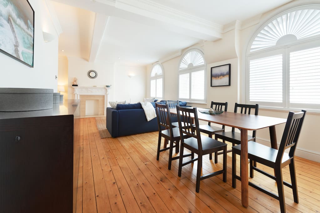 With a dining table and wooden floors...