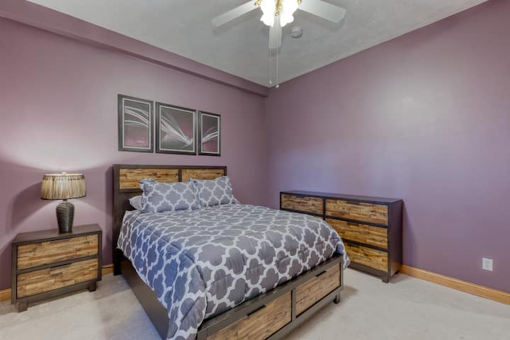 The second main floor bedroom with queen bed is well-appointed with drawer and closet space, ceiling fan, and offers all the comforts of home. Leave the window open and fall asleep to the soothing sounds of the grand fountain just outside