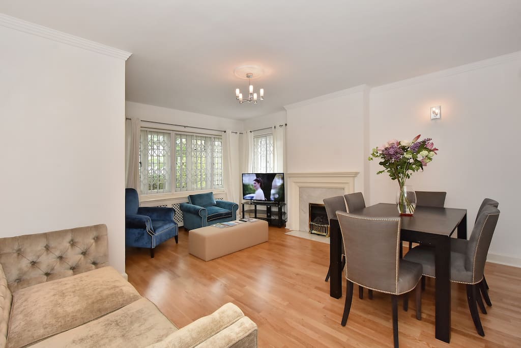 The bright, spacious Lounge and dining area with large, flat screen TV and fireplace