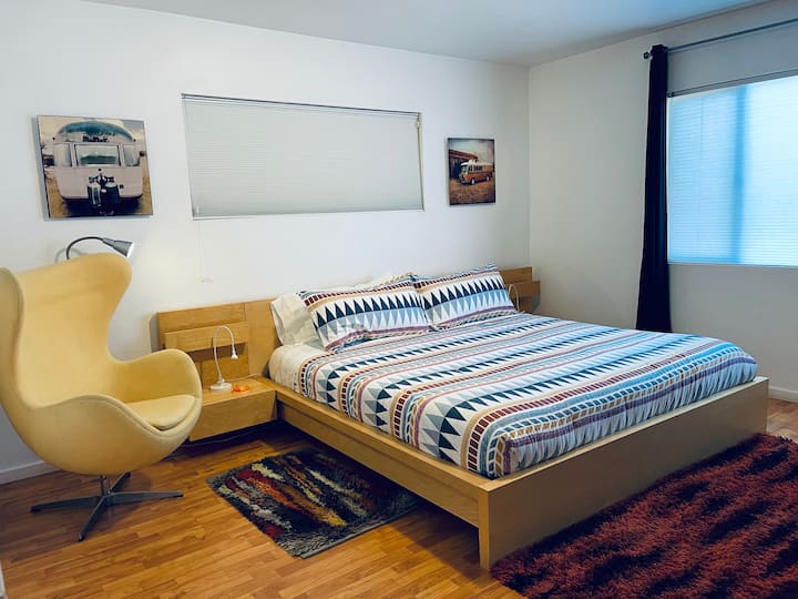 Large bedroom with King bed and cozy egg chair
