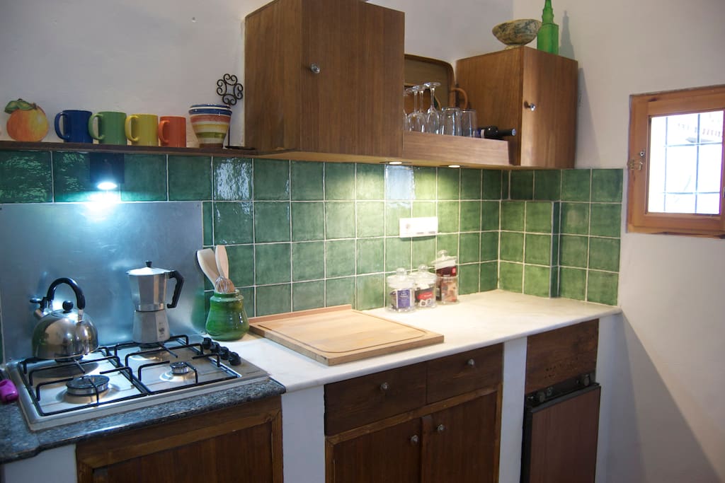 Kitchen with fridge and hot water.