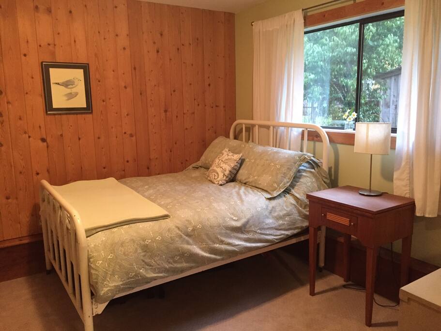 Full size bed on the ground floor of home.