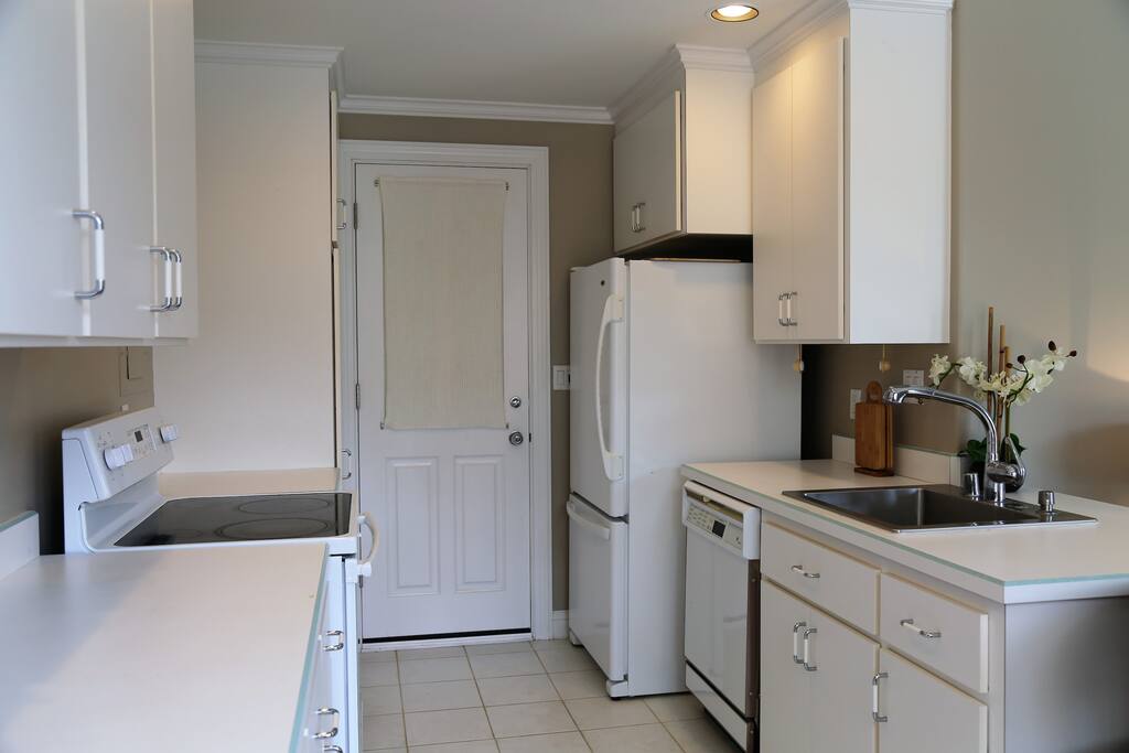 Full size kitchen with everything you need: stove, refrigerator and dishwasher