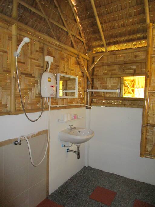 bathroom : shower with hot water, washstand and toilet