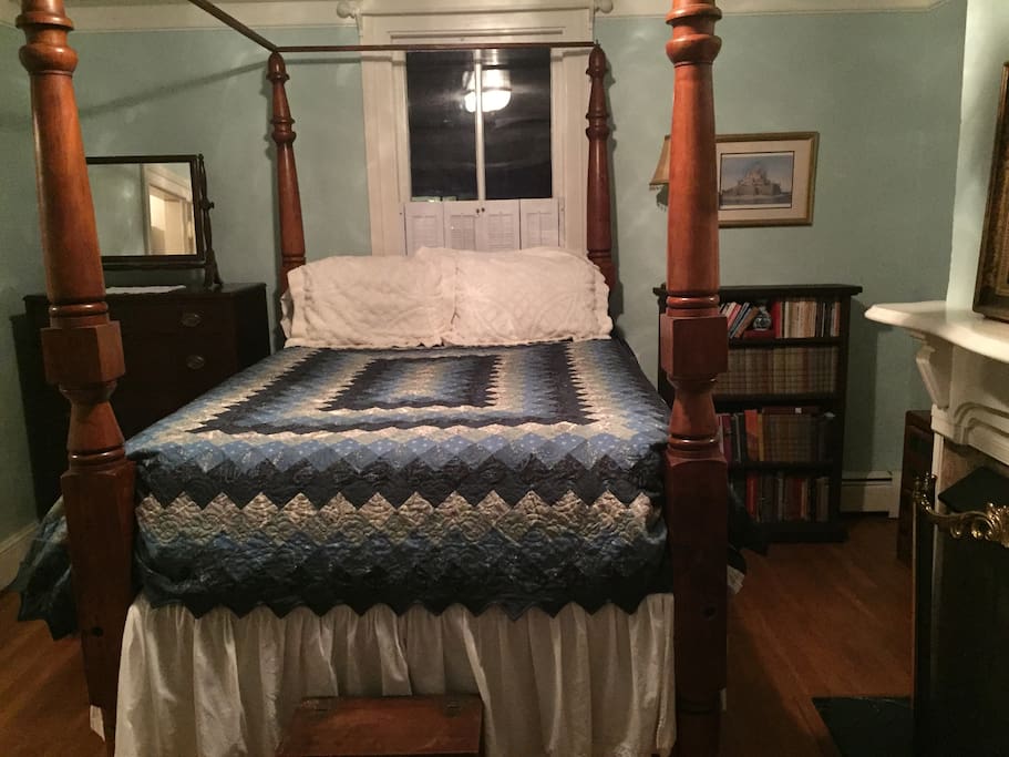 Regal antique 4 post bed adorned with custom quilts