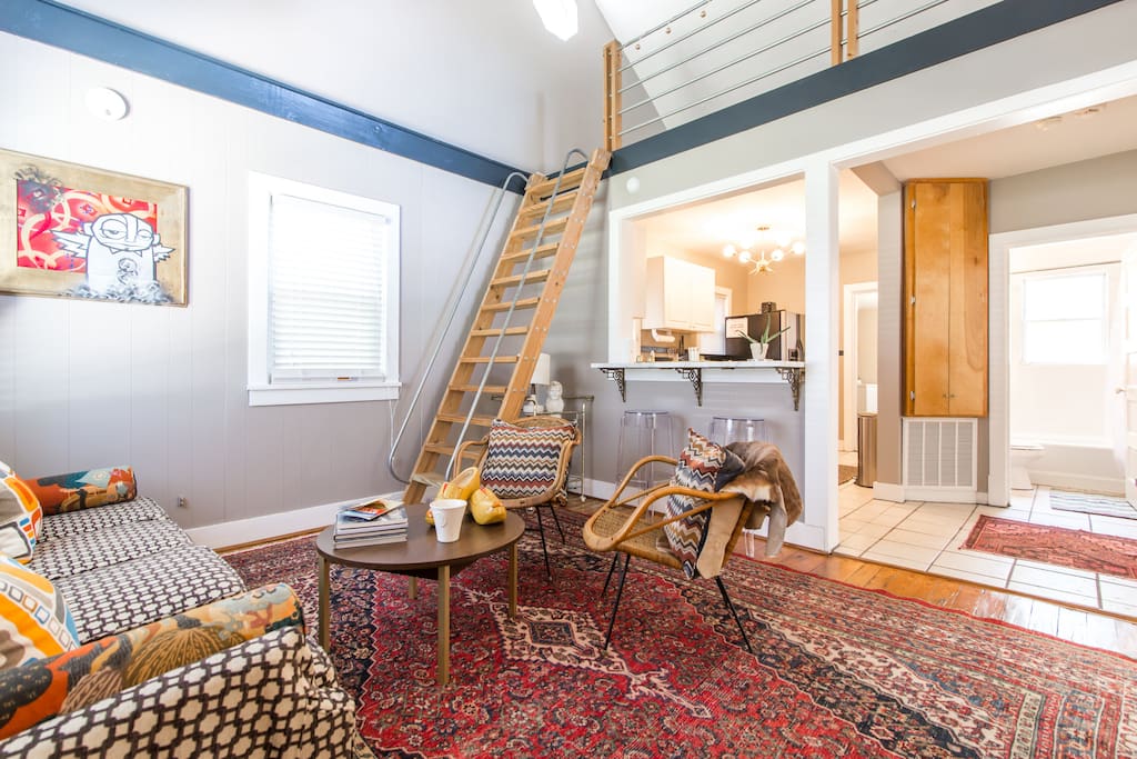 Welcome to our special Mod Cape Cod - in the heart of East Nashville! Living room, looking up into the bright loft (which holds a cozy nook/office space and houses a deluxe full-sized air mattress for extra guests).