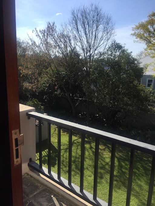 Small balcony that overlooks the quiet ,lush garden