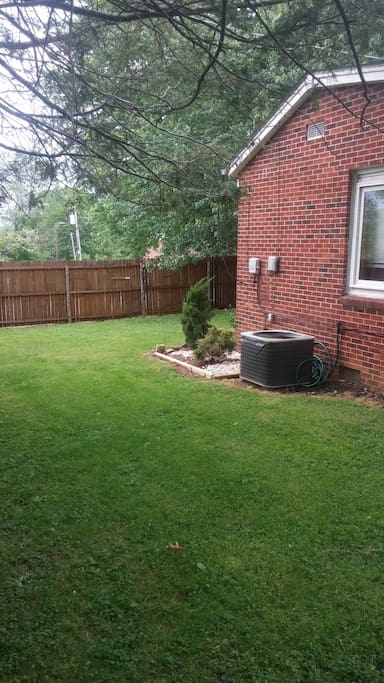 A privacy fence surrounds 3 parts of the yard.