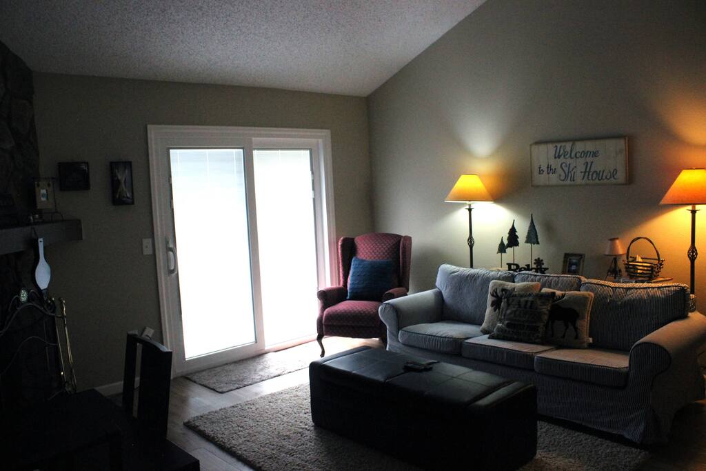 The Living Area with sliding glass door to the deck and view of the mountains.