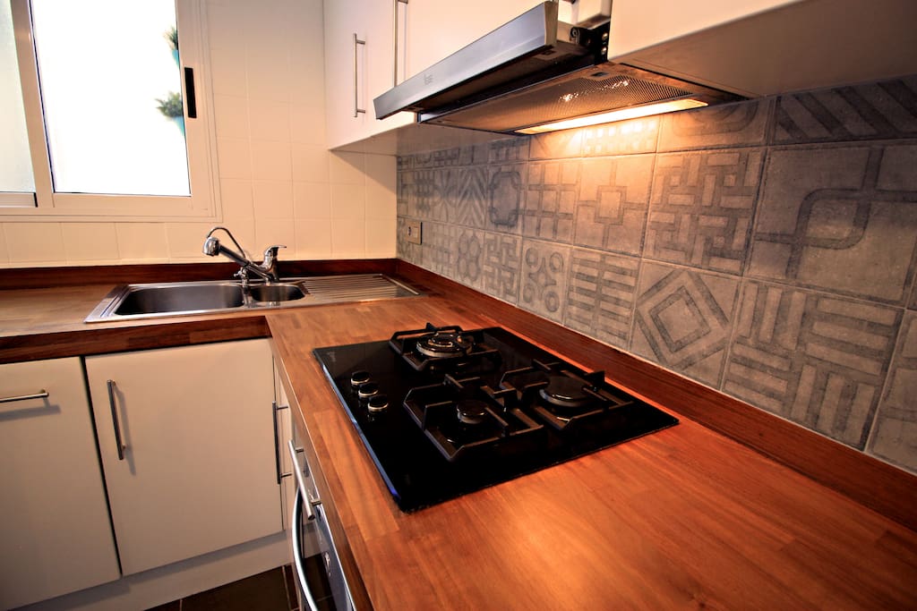 Kitchen with vintage mosaics -XIX century- and iroko wood.