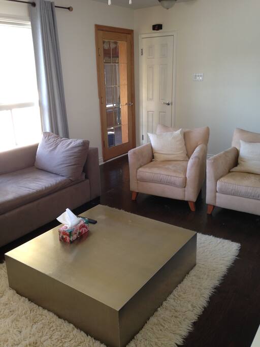 Living area leading out to sunroom and main entrance.