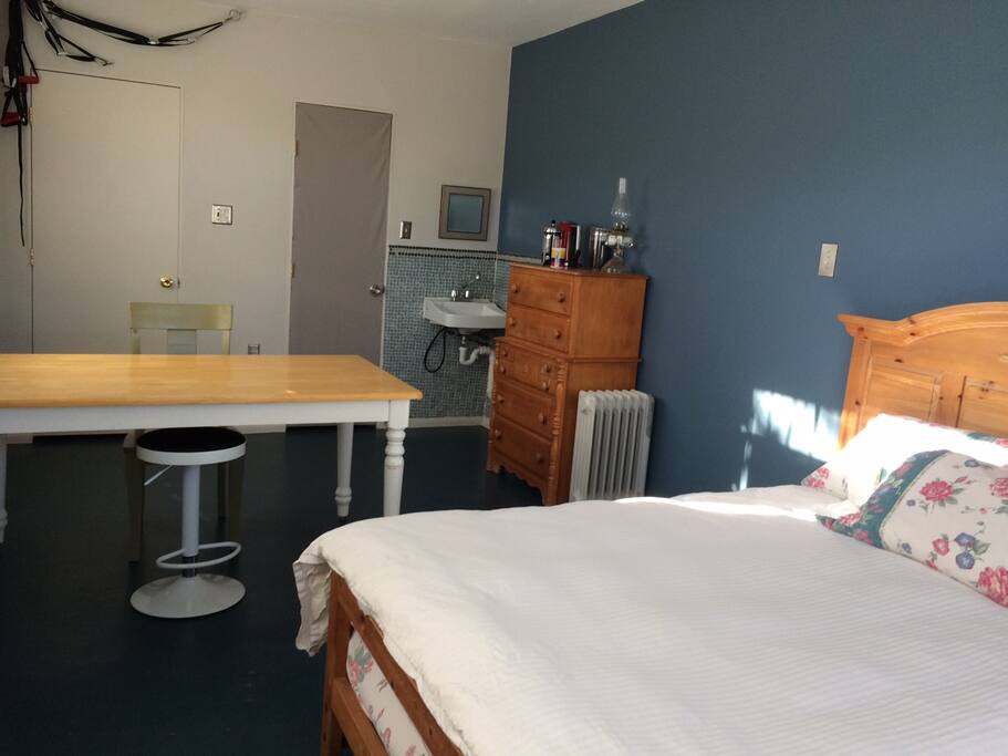 The grey door is to the guest restroom, the white door leads to the kitchen.