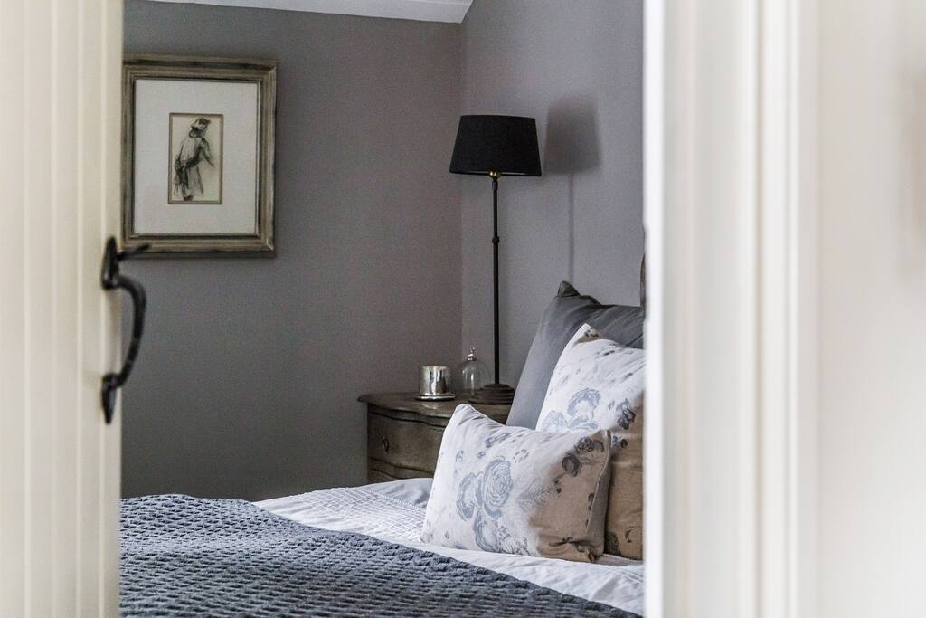 View from the reception room into the bedroom. Designer fabrics and seagrass carpets.