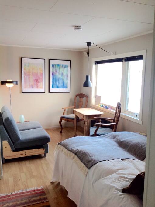 The studio is 20m2. The room feels light and airy because of the large windows, but also cozy due to muted colours and comfy furniture. Just like the bed and the sofa, the dining area stylishly seats two, and has a perfect view for aurora spotting when you switch off all the lights in the apartment. Yes, that's right: northern lights for dinner!