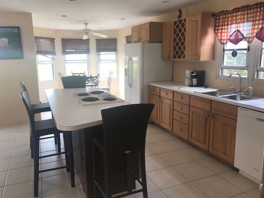 Kitchen area with dining area in the background