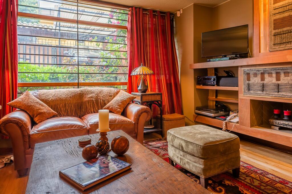 This is the entertainment center across from the leather sofas. The entertainment area contains a large screen television; stereo and full surround sound system