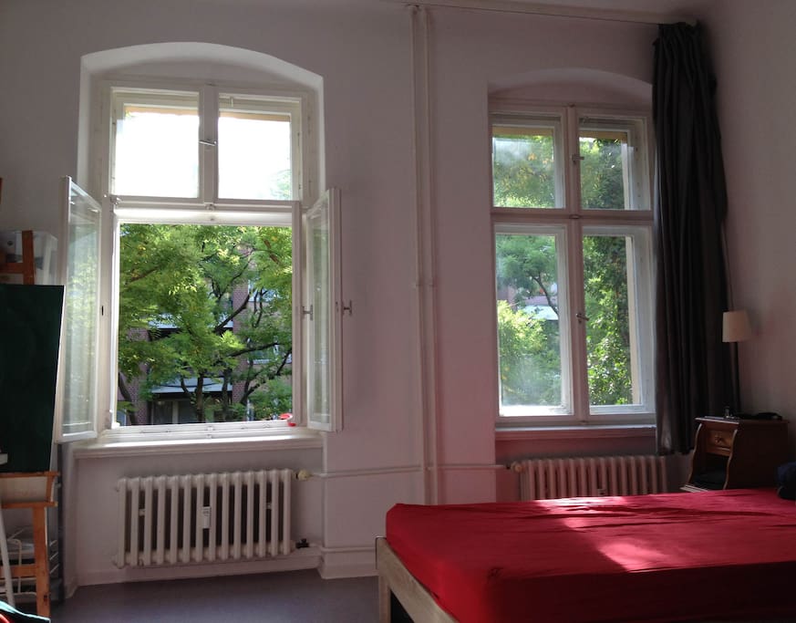 Bright room with big windows on a calm street
