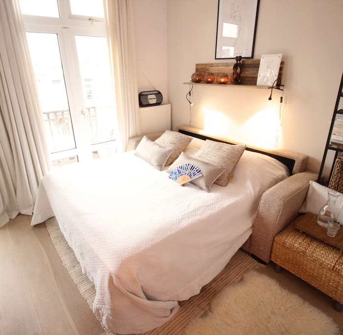 The Airb&B bedroom has a very comfortable bed with an extra king-size mattress on it and blanket & pillows filled with down.