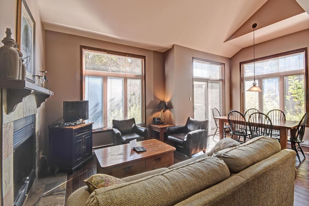 Bright airy family room and dining area with cathedral ceiling