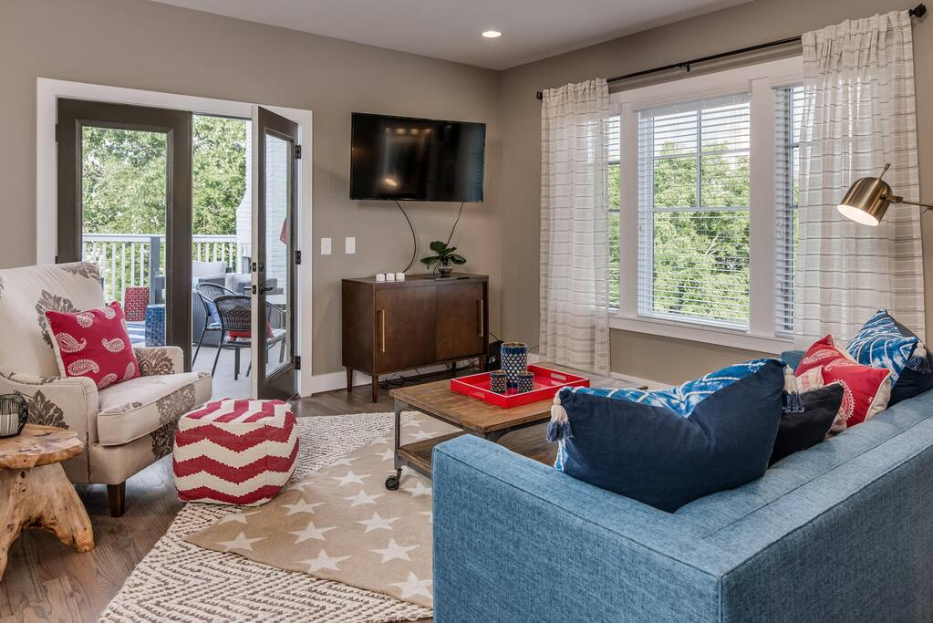 Lounge Room just inside the roof deck with TV, half bath & wet bar