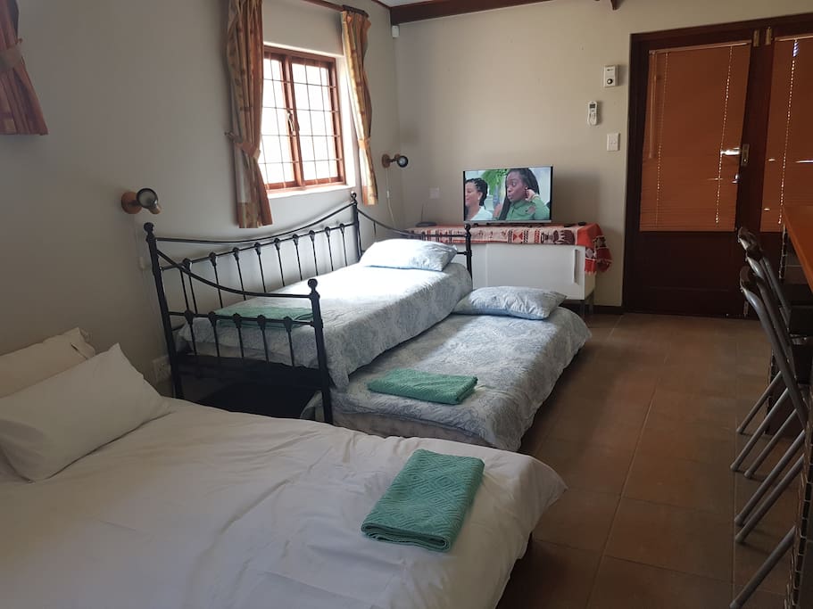 King size bed and a day bed that can either be two beds or a couch. Satellite Tv (Dstv full bouquet) and wifi connection.