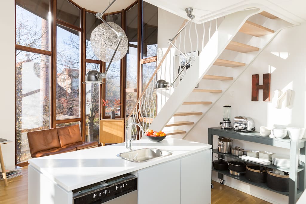 Fully equipped kitchen with massive amounts of light coming in.