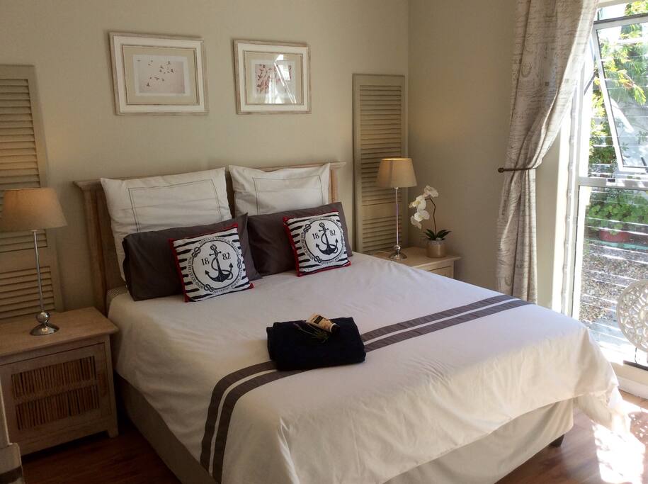Sunny master bedroom with queen size bed & built in cupboard