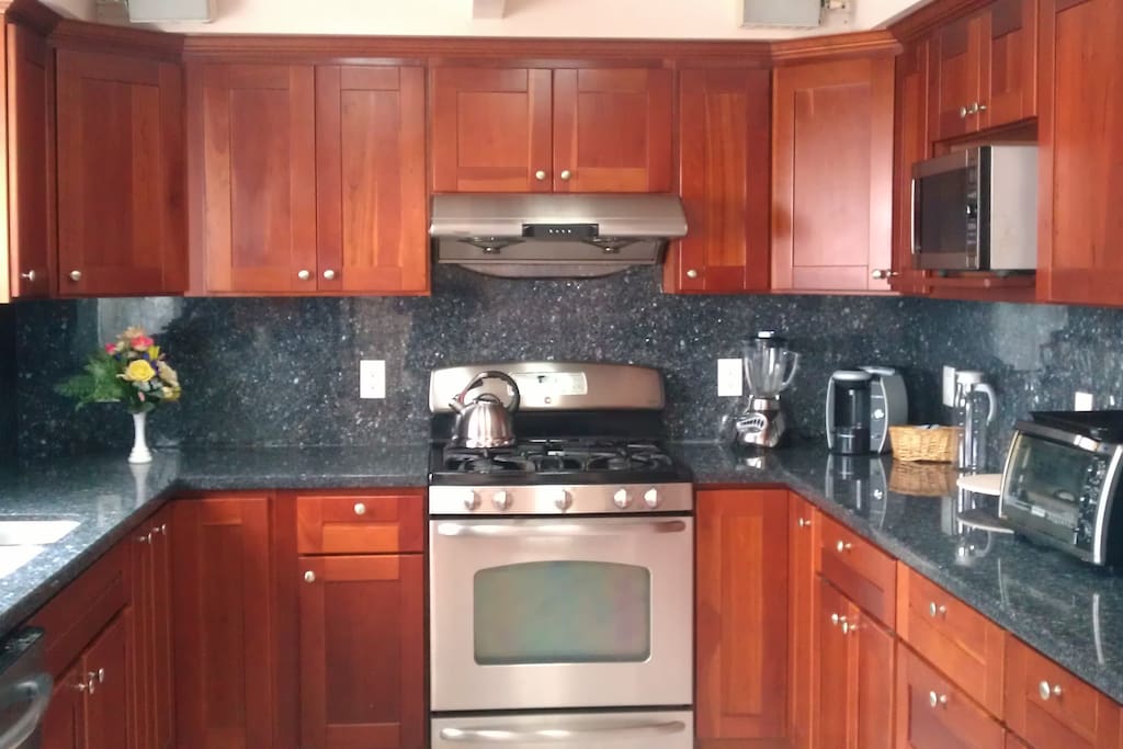 New, granite counter-tops, microwave, coffee-maker, pots and glassware, gas stove/oven.