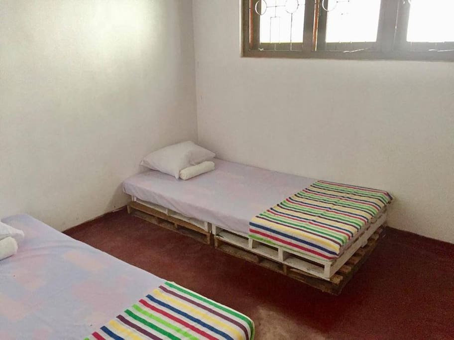 Standard twin room with fan and mosquito net