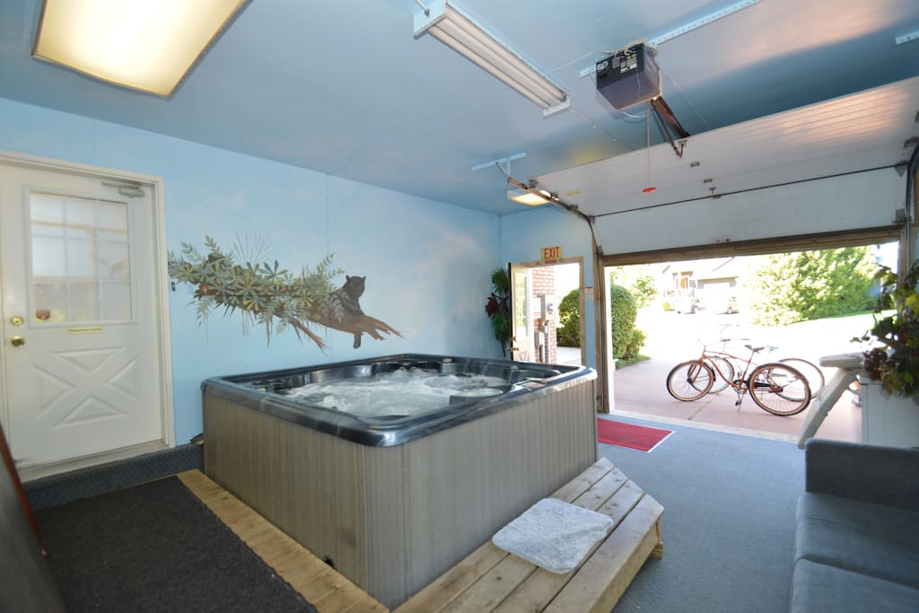 Our 8 man hot tub is located is the garage for all year around use. The garage door can roll up in the summer and winter. Jump from hot tub to snow and back if you dare.