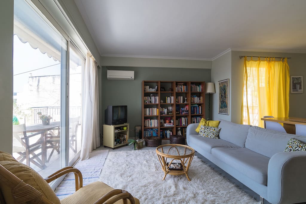 Spacious living room with comfortable sofa overlooking the synny terrace