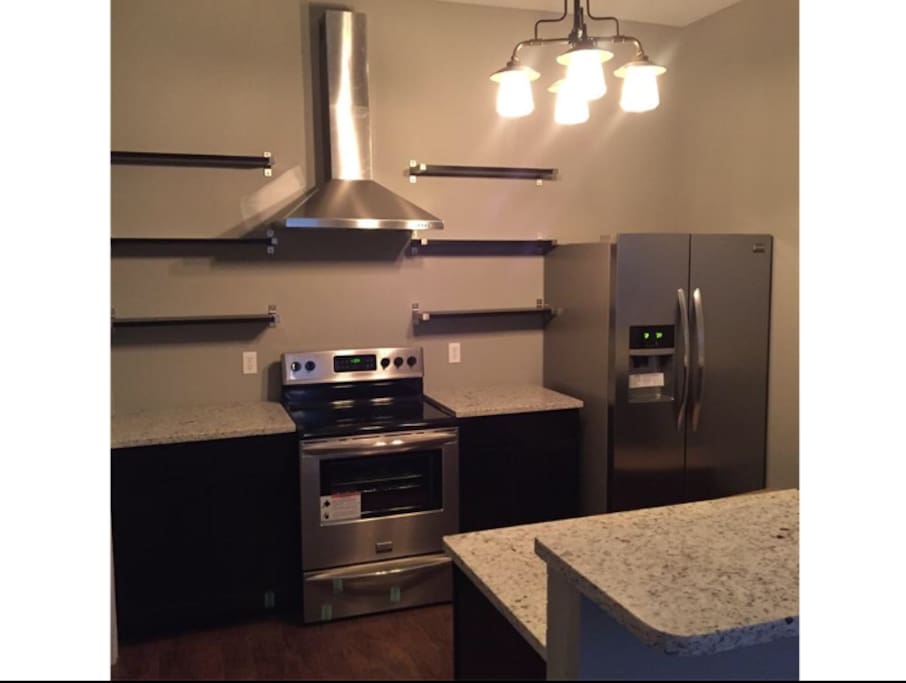 Kitchen comes with electric stove, microwave, oven, fridge and dishwasher.