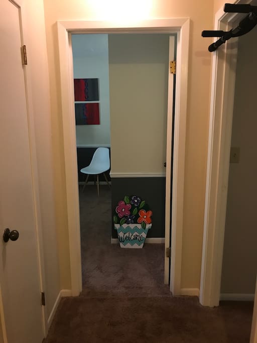 Bedroom is at end of first hall with a warm, flower basket welcome sign designator