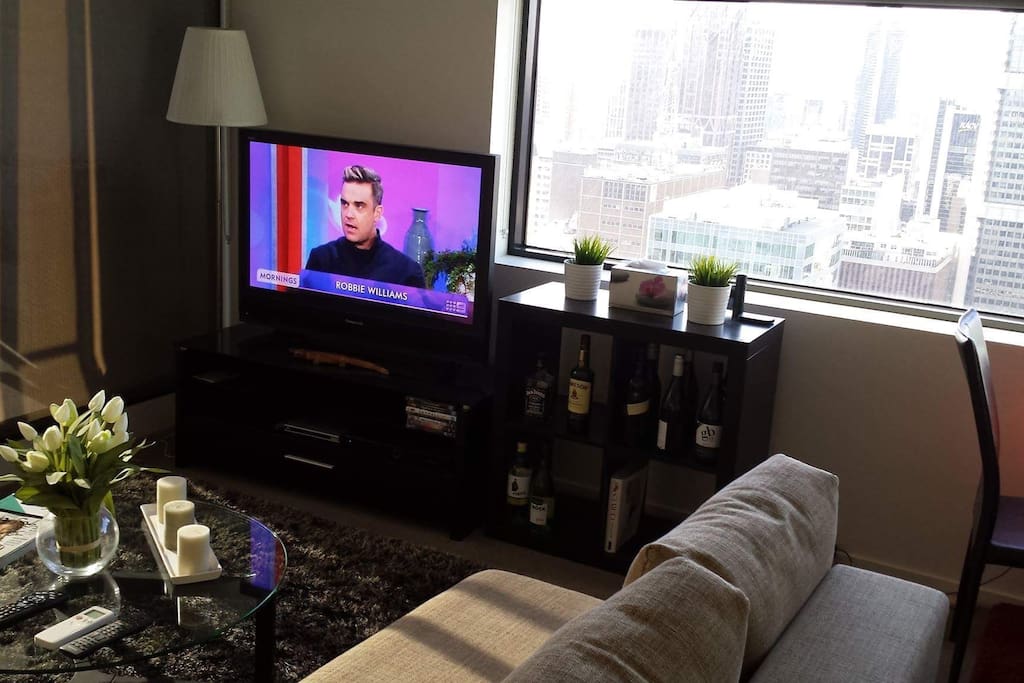 Lounge sofa area with full Foxtel tv