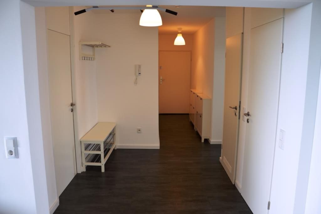 gräumiger Flur mit Schuhschränken und Garderobe